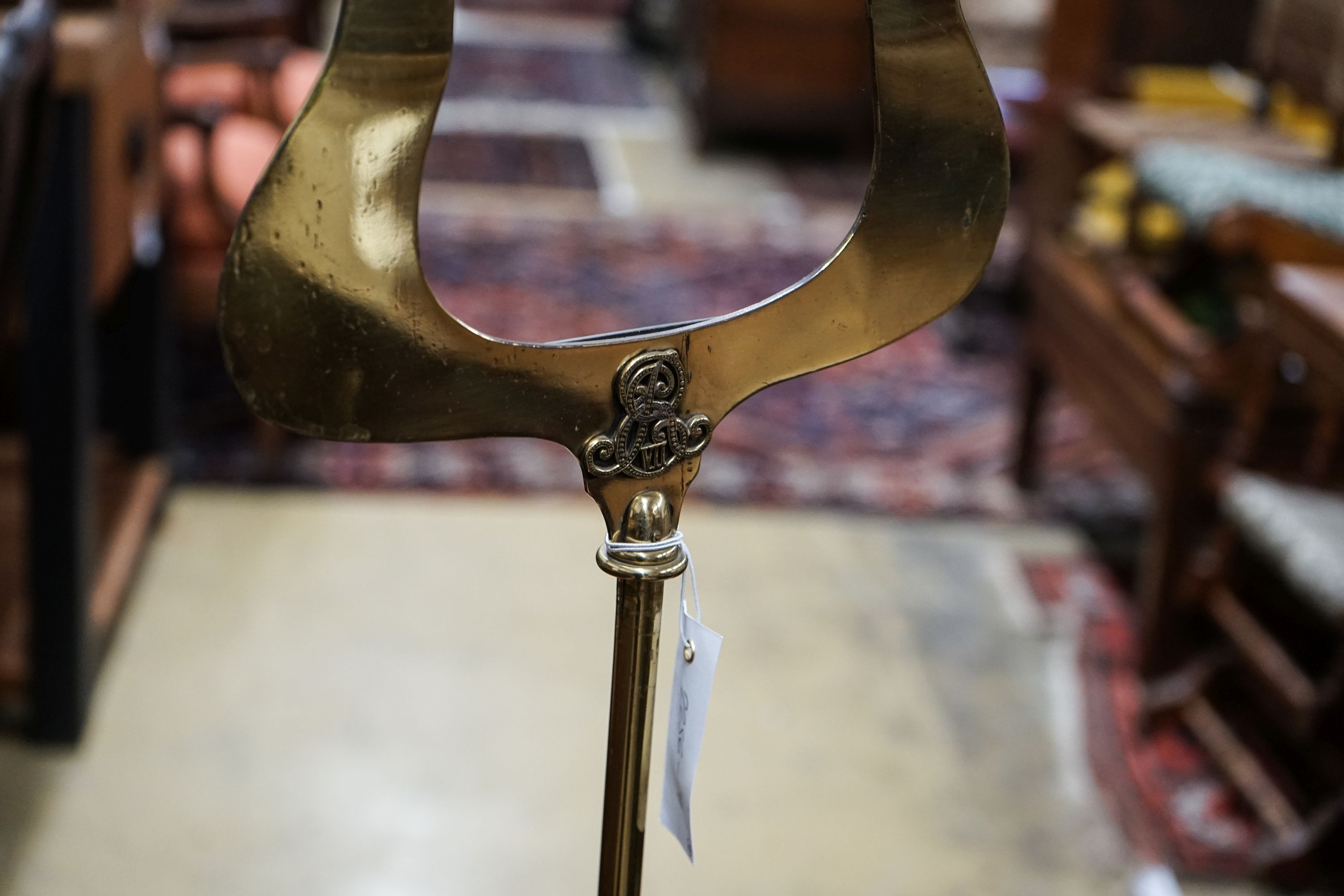 An Edwardian brass music stand and stool